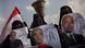 Three Egyptian women veiled in black hold up posters of Ahmed Shafiq during prodemocracy protests in 2012. Three Egyptian women veiled in black hold up posters of Ahmed Shafiq during prodemocracy protests in 2012.