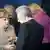 Bundeskanzlerin Angela Merkel (CDU) und der italienische Ministerpraesident Mario Monti (M.) unterhalten sich am Donnerstag (28.06.12) beim EU-Gipfel in Bruessel im Rahmen des Familienfotos neben EU-Ratspraesident Herman van Rompuy. Der Tod stand dem Euro in Bruessel Pate. Nachdem Kanzlerin Merkel die Verhinderung von Euro-Bonds an ihre Lebenserwartung geknuepft hatte, langte Italiens Regierungschef Mario Monti ins Feuer: Er warnte vor einer Katastrophe, sollte der EU-Gipfel scheitern. Wenn die Italiener entmutigt wuerden, koennte das "politische Kraefte" freisetzen, die die europaeische Integration und den Euro "zur Hoelle fahren lassen". (zu dapd-Text) Foto: Guido Bergmann/dapd.