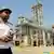 An Iran guard stands in front of a petrochemical complex in Mahshahr in the province of Khuzestan in the southwest of Iran.