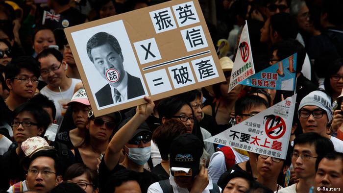 A protester holds a sign mocking new leader Leung Chun-ying during a demonstration urging him to step down in Hong Kong July 1, 2012, during the 15th anniversary of the territory's handover to China. Leung was sworn into office on Sunday by Chinese President Hu Jintao for a five-year term in which he will confront challenges ranging from human rights to democracy after a tumultuous year of transition and protest. REUTERS/Bobby Yip (CHINA - Tags: POLITICS ANNIVERSARY CIVIL UNREST)