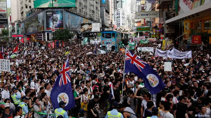 Thousands of protesters, some carrying Hong Kong colonial flags, crowd a street urging new Hong Kong leader Leung Chun-ying to step down at Hong Kong's shopping Causeway Bay district July 1, 2012, during the 15th anniversary of the territory's handover to China. Leung was sworn into office on Sunday by Chinese President Hu Jintao for a five-year term in which he will confront challenges ranging from human rights to democracy after a tumultuous year of transition and protest. REUTERS/Bobby Yip (CHINA - Tags: POLITICS ANNIVERSARY CIVIL UNREST)