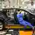 Opel worker assembles Isignia car at Rüsselsheim plant