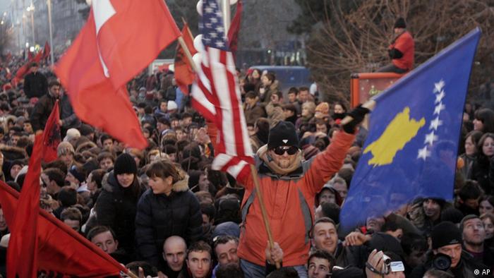 Kosovars celebrate independence in Pristina, Kosovo, waving the new Kosovo flag, right, Sunday, Feb. 17, 2008. Kosovo's parliament declared the disputed territory a nation on Sunday, mounting a historic bid to become an independent and sovereign state backed by the U.S. and key European allies but bitterly contested by Serbia and Russia. (AP Photo/Darko Bandic)