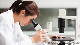 Focused female science student looking in a microscope © WavebreakmediaMicro #35348146
