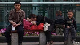 Migrant workers take a rest at the Tianfu Square in Chengdu in southwest China's Sichuan province on Sunday, March 21, 2010.(Photo By Evens Lee/Color China Photo/ddp images/AP Images)