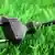 a black electrical plug on green grass