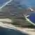 Das Luftbild vom August 1990 zeigt die nordfriesische Insel Sylt. Der Orkan am vergangenen Sonntag (30.01.2000) hat wieder einige Meter vom Sandgürtel der nördlichsten Insel Deutschlands abgetragen. dpa/lno (zu lno Thema des Tages vom 31.01.2000)