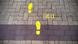 A picture of yellow footsteps on a Brussels street with the letters EU to the right of them. A picture of yellow footsteps on a Brussels street with the letters EU to the right of them.