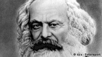 Black and white head shot of Karl Marx as an elderly man, with white hair and beard