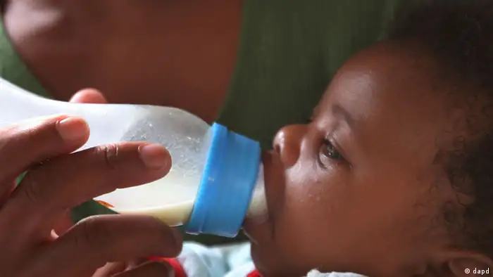 A baby being fed with formula milk