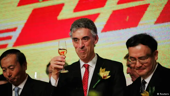 Deutsche Post DHL Chief Executive Officer Frank Appel (C) celebrates during the inauguration of the DHL North Asia Hub in Shanghai July 12, 2012. REUTERS/Carlos Barria (CHINA - Tags: BUSINESS TRANSPORT)