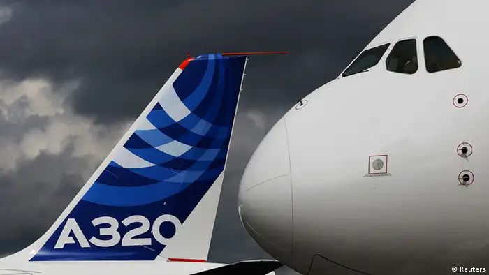 The nose cone of an Airbus A380 overlooks the tail fin of an Airbus A320 at the Farnborough Airshow 2012 in southern England July 10, 2012. REUTERS/Luke MacGregor (BRITAIN - Tags: TRANSPORT BUSINESS)