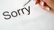 Рука женщины и надпись "Sorry" Рука женщины и надпись "Sorry"
