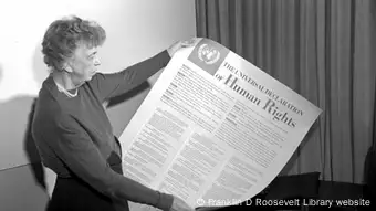 Eleanor Roosevelt holds a printed version of the Universal Declaration of Human Rights