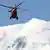 A rescue worker helicopter returning from the avalanche site, lands in Chamonix, French Alps, Thursday, July, 12, 2012.