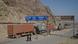 Men walk near a road sign showing the distance to cities in Afghanistan, as trucks drive past in the northwest town of Torkham, at the border crossing to Pakistan, July 4, 2012 (Photo: REUTERS/Shahid Shinwari) Men walk near a road sign showing the distance to cities in Afghanistan, as trucks drive past in the northwest town of Torkham, at the border crossing to Pakistan, July 4, 2012 (Photo: REUTERS/Shahid Shinwari)