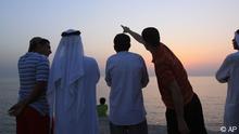 Bahraini men scan the sky at dusk Wednesday, Aug. 11, 2010, in the village of Karzakan, Bahrain, searching for the crescent moon on the first day of the Islamic holy month of Ramadan. After spotting the faint sliver of a moon, the men broke their daily fast with dates and juice and prayed together along the Persian Gulf seashore. (ddp images/AP Photo/Hasan Jamali)