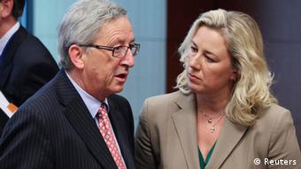 Luxembourg's Prime Minister and Eurogroup chairman Jean-Claude Juncker talks to Finland's Finance Minister Jutta Urpilainen (R) during an eurozone finance ministers meeting at the EU Council in Brussels July 9, 2012.