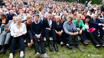 Members of AUF (The Labour Youth Organisation) sit with guests and relatives of those who died a year ago, on Utoeya island July 22, 2012, during the one year anniversary of the twin Oslo-Utoeya massacre by self confessed killer Anders Behring Breivik. Breivik, who said his mostly teenage victims were traitors because they supported multiculturalism and Muslim immigration, detonated a bomb outside parliament that killed eight, then shot dead 69 at the ruling Labour Party's youth camp on Utoeya. AUF Chairman Eskil Pedersen (2nd L), Norway's Prime Minister Jens Stoltenberg (3rd L), Norway's former Prime Minister Gro Harlem Brundtland (5th R), Denmark's Prime Minister Helle Thorning-Schmidt (3rd R) , Swedish social democratic politician Mona Sahlin (2nd R) and Norway's Foreign Minister Jonas Gahr Stoere (R) sit in the front row. REUTERS/Heiko Junge/NTB Scanpix (NORWAY - Tags: POLITICS CIVIL UNREST ANNIVERSARY TPX IMAGES OF THE DAY) THIS IMAGE HAS BEEN SUPPLIED BY A THIRD PARTY. IT IS DISTRIBUTED, EXACTLY AS RECEIVED BY REUTERS, AS A SERVICE TO CLIENTS. NORWAY OUT. NO COMMERCIAL OR EDITORIAL SALES IN NORWAY. NO COMMERCIAL SALES