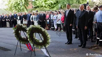 Norway's King Harald (R) and Prime Minister Jens Stoltenberg attend a wreath laying ceremony during a ceremony to mark the one year anniversary of the twin Oslo-Utoeya massacre by self confessed killer Anders Breivik, near the heavily damaged government building in Oslo July 22, 2012. REUTERS/Berit Roald/NTB Scanpix/Pool (NORWAY - Tags: POLITICS ROYALS ANNIVERSARY CIVIL UNREST TPX IMAGES OF THE DAY)