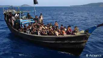 A powerless or engineless boat loaded with Rohingya refugees, moments before it was rescued by Indian Coastguards off Andaman Islands. Thai authorities forced the boatpeople board this boat which was then towed out to the middle of the sea and left to drift with very little food and water. Copyright: Asiapics 2010, near Andaman & Nicobar Islands, India