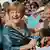 German Chancellor Angela Merkel (CDU) signs autographs upon her arrival at the opening of the Bayreuth Festival 2012 in Bayreuth, Germany, 25 July 2012. The one-month festival is Germany's most prestigious culture event. Photo: Marc Mueller dpa/lby/ef pixel