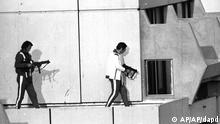 Two west German policemen, armed with submachine guns and wearing athletes tracksuits, get into position on the roof of the building where armed Palestinian terrorists are holding Israel Olympic team members hostage. The terrorists have threatened to kill the hostages unless approximately 200 Palestinian terrorists held in Israel are released. Munich, Sep. 5, 1972. (ddp images/AP Photo) ISRAEL OUT