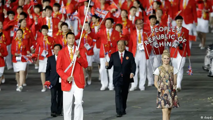 China's Jianlian Yi carries the national flag during the Opening Ceremony at the 2012 Summer Olympics, Friday, July 27, 2012, in London. (AP Photo/Mark Humphrey)