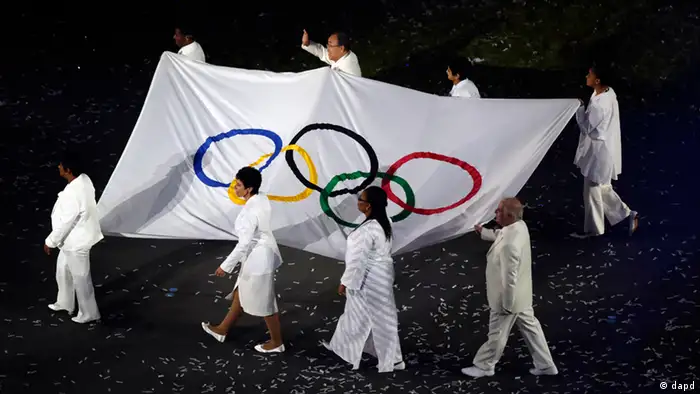 The OIympic flag is carried around the stadium during the Opening Ceremony at the 2012 Summer Olympics, Friday, July 27, 2012, in London. (AP Photo/Charlie Riedel)