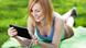 Woman lying on grass with digital tablet © Edyta Pawlowska Woman lying on grass with digital tablet © Edyta Pawlowska