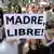 A protester with a banner reading "Free Mother" during a protest against abortion law reform in Madrid