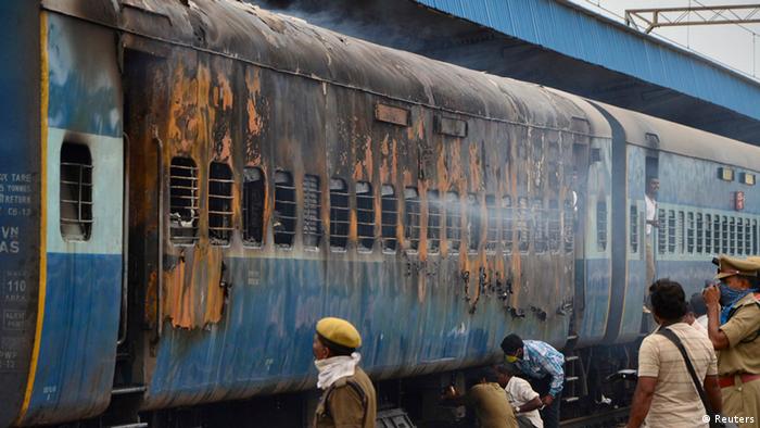 A burnt carriage of a passenger train is pictured at the Nellore railway station, in the southern Indian state of Andhra Pradesh July 30, 2012. A Chennai-bound express train caught fire on Monday in a pre-dawn accident in Andhra Pradesh, killing at least 30 passengers. The fire broke out in a coach of the Tamil Nadu Express near Nellore, around 500 kilometres (311 miles) from Hyderabad, when most of the passengers were asleep. REUTERS/Stringer (INDIA - Tags: DISASTER TRANSPORT TPX IMAGES OF THE DAY)