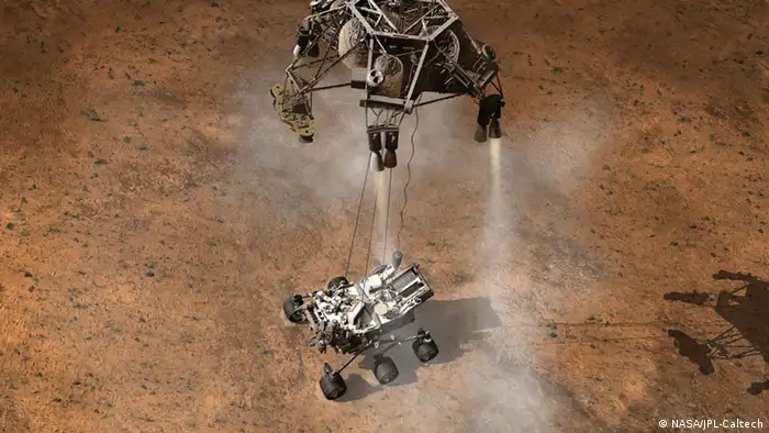 Curiosity Touching Down, Artist's Concept This artist's concept depicts the moment that NASA's Curiosity rover touches down onto the Martian surface. The entry, descent, and landing (EDL) phase of the Mars Science Laboratory mission begins when the spacecraft reaches the Martian atmosphere, about 81 miles (131 kilometers) above the surface of the Gale crater landing area, and ends with the rover safe and sound on the surface of Mars. Entry, descent, and landing for the Mars Science Laboratory mission will include a combination of technologies inherited from past NASA Mars missions, as well as exciting new technologies. Instead of the familiar airbag landing systems of the past Mars missions, Mars Science Laboratory will use a guided entry and a sky crane touchdown system to land the hyper-capable, massive rover. The sheer size of the Mars Science Laboratory rover (over one ton, or 900 kilograms) would preclude it from taking advantage of an airbag-assisted landing. Instead, the Mars Science Laboratory will use the sky crane touchdown system, which will be capable of delivering a much larger rover onto the surface. It will place the rover on its wheels, ready to begin its mission after thorough post-landing checkouts. The new entry, descent and landing architecture, with its use of guided entry, will allow for more precision. Where the Mars Exploration Rovers could have landed anywhere within their respective 93-mile by 12-mile (150 by 20 kilometer) landing ellipses, Mars Science Laboratory will land within a 12-mile (20-kilometer) ellipse! This high-precision delivery will open up more areas of Mars for exploration and potentially allow scientists to roam virtually where they have not been able to before. In the depicted scene, Curiosity is touching down onto the surface, suspended on a bridle beneath the spacecraft's descent stage as that stage controls the rate of descent with four of its eight throttle-controllable rocket engines. The rover is connected to the descent stage by three nylon tethers and by an umbilical providing a power and communication connection. When touchdown is detected, the bridle will be cut at the rover end, and the descent stage flies off to stay clear of the landing site. The Mars Science Laboratory spacecraft is being prepared for launch during Nov. 25 to Dec. 18, 2011. Landing on Mars is in early August 2012. In a prime mission lasting one Martian year (nearly two Earth years) researchers will use the rover's tools to study whether the landing region has had environmental conditions favorable for supporting microbial life and for preserving clues about whether life existed. NASA's Jet Propulsion Laboratory, a division of the California Institute of Technology, Pasadena, Calif., manages the Mars Science Laboratory Project for the NASA Science Mission Directorate, Washington. More information about Curiosity is at http://www.nasa.gov/msl and http://mars.jpl.nasa.gov/msl/ . Image credit: NASA/JPL-Caltech