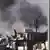 This image made from amateur video released by the Ugarit News and accessed Tuesday, July 31, 2012, purports to show black smoke rising from buildings in Aleppo, Syria. United Nations observers say fighter jets are firing on anti-government rebels in Aleppo. The airstrikes come after President Bashar Assad issued a rare statement today, urging his armed forces to step up the fight against the rebels. (Foto:Ugarit News via AP video/AP/dapd) THE ASSOCIATED PRESS IS UNABLE TO INDEPENDENTLY VERIFY THE AUTHENTICITY, CONTENT, LOCATION OR DATE OF THIS HANDOUT PHOTO