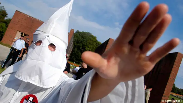VALLEY FORGE, PA - SEPTEMBER 25: A member of the Ku Klux Klan salutes during American Nazi Party rally at Valley Forge National Park September 25, 2004 in Valley Forge, Pennsylvania. Hundreds of American Nazis from around the country were expected to attend. (Photo by William Thomas Cain/Getty Images)