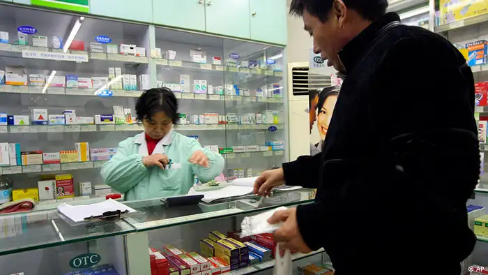 A customer, right, buys medicine at a pharmacy Thursday Dec. 13, 2007, in Shanghai, China. China's food and drug safety agency has revoked the license of a company responsible for making tainted leukemia drugs blamed for causing leg pains and partial paralysis among dozens of patients. (ddp images/AP Photo)