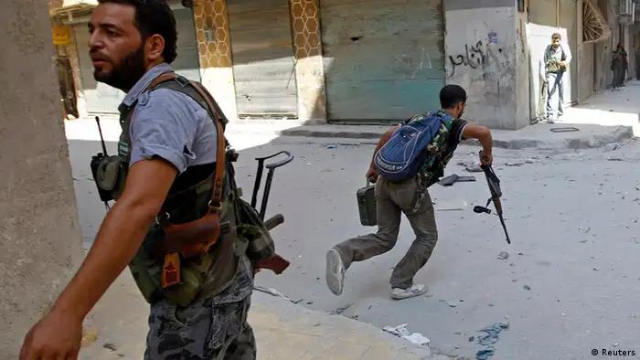 A Free Syrian Army fighter runs across a street dodging Syrian Army bullets in the Salah al- Din neighbourhood of central Aleppo August 5, 2012. REUTERS/Goran Tomasevic (SYRIA - Tags: CIVIL UNREST POLITICS TPX IMAGES OF THE DAY)