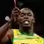 Jamaica's Usain Bolt gestures after winning the men's 100m final with an Olympic record during the London 2012 Olympic Games at the Olympic Stadium August 5, 2012.