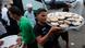 Volunteers carry food for an Iftar meal Volunteers carry food for an Iftar meal