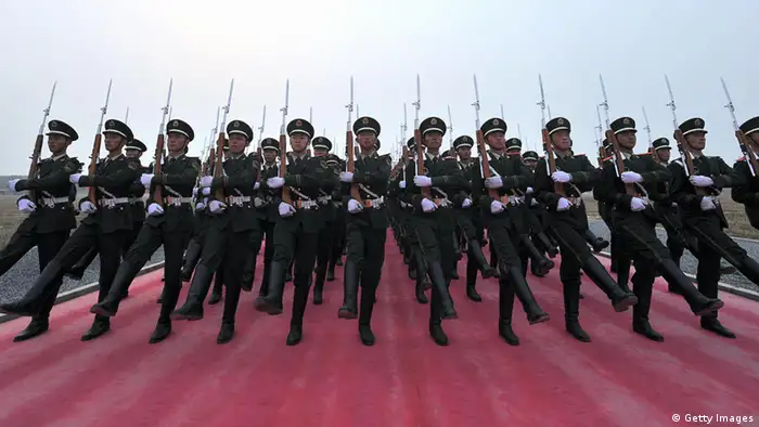TO GO WITH STORY China-politics-60years-military BY DAN MARTIN In a picture taken on September 25, 2009 Chinese honour guards applaud their comrades as they rehearse for the National Day parade in Beijing . The People's Liberation Army marched into Beijing in 1949 as a ragtag peasant force, but this week it will show what a difference six decades and billions of dollars in funding can make. CHINA OUT AFP PHOTO (Photo credit should read AFP/AFP/Getty Images)