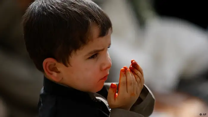 An Afghan boy offers prayers during Eid al-Fitr that marks the end of the holy fasting month of Ramadan in Kabul, Afghanistan, Tuesday, Aug. 30, 2011. (AP Photo/Rafiq Maqbool)