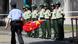 A police officer holds a Chinese national flag outside the Japanese consulate in Shanghai August 16, 2012. Protesters outside the consulate were demanding the release of detained activists after they landed on the disputed islands called Senkaku in Japan, or Diaoyu in China. China urged Japan on Wednesday to immediately and unconditionally release 14 Chinese nationals held over a protest landing on disputed islands that have long been a source of tension between the two big Asian powers. REUTER/Aly Song (CHINA - Tags: POLITICS CIVIL UNREST) A police officer holds a Chinese national flag outside the Japanese consulate in Shanghai August 16, 2012. Protesters outside the consulate were demanding the release of detained activists after they landed on the disputed islands called Senkaku in Japan, or Diaoyu in China. China urged Japan on Wednesday to immediately and unconditionally release 14 Chinese nationals held over a protest landing on disputed islands that have long been a source of tension between the two big Asian powers. REUTER/Aly Song (CHINA - Tags: POLITICS CIVIL UNREST)