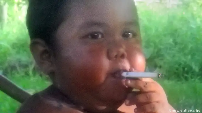 Der zweijährige indonesische Junge Ardi Rizal raucht in seinem Elternhaus auf Sumatra am 16.05.2010 eine Zigarette. Der Kette rauchende Zweijährige ist in Indonesien jetzt auf Entzugs-Kur. Ardi Rizal sei in der Obhut des Kinderschutzbundes, sagte deren Vorsitzender am Samstag (05.06.2010) Nach seinen Angaben werden zwei weitere nikotinsüchtige Kleinkinder behandelt. Es gebe zwar keine Statistiken, aber das Rauchen sei unter Kleinkindern weit verbreitet. Der Fall Ardi war bekannt geworden, nachdem Freunde ein Video des rauchenden Kindes auf der Internet-Videoplattform YouTube gestellt hatten. Der Clip ging um die Welt. Die Eltern sagten, der Junge habe sich mit 18 Monaten erstmals eine Zigarette seines Vaters genommen. Er rauchte bald 40 Zigaretten am Tag und bekam Wutanfälle, wenn er keinen Nachschub bekam. Foto: AHMAD NAAFI/SRIWIJAYA POST/AFP/dpa *** NUR ZUR REDAKTIONELLEN VERWENDUNG *** +++(c) dpa - Bildfunk+++