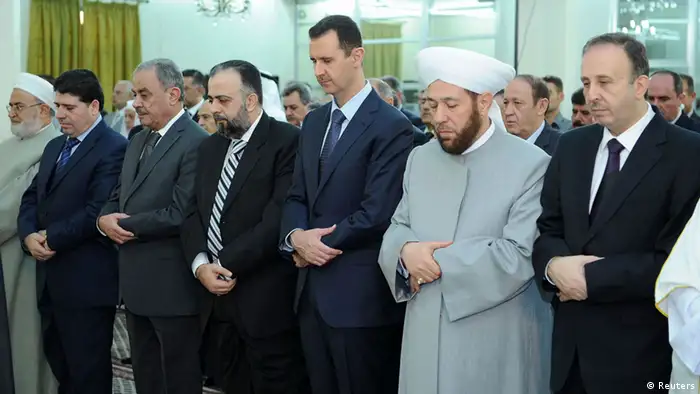 Syria's President Bashar al-Assad (3nd R )attends Eid Al Fitr prayers at al-Hamad mosque in Damascus August 19, 2012, in this handout photograph released by Syria's national news agency SANA. REUTERS/Sana/Handout (SYRIA - Tags: POLITICS RELIGION) FOR EDITORIAL USE ONLY. NOT FOR SALE FOR MARKETING OR ADVERTISING CAMPAIGNS. THIS IMAGE HAS BEEN SUPPLIED BY A THIRD PARTY. IT IS DISTRIBUTED, EXACTLY AS RECEIVED BY REUTERS, AS A SERVICE TO CLIENTS