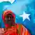 A woman holds the Somali flag