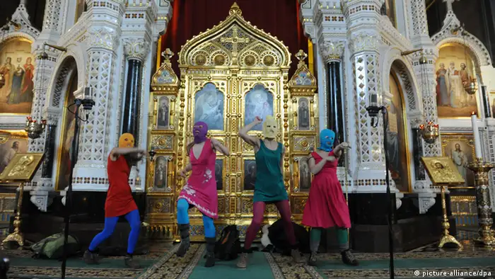 ITAR-TASS: MOSCOW, RUSSIA. FEBRUARY 21, 2012. Masked members of Pussy Riot feminist punk group perform during their 'flashmob'-style protest inside Moscow's Cathedral of Christ the Savior. The girls were marched by guards out of the cathedral. (Photo ITAR-TASS/ Mitya Aleshkovsky)