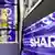 Sharp's coporate logo is seen as a shopper walks past it at an electronics shop in downtown Tokyo