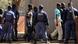 Police keep watch during the arrival of some of the 250 mine workers who were arrested last Thursday when they had a shoot out with police, at a Garankuwa court outside Pretoria August 20, 2012. A quarter of the workforce returned on Monday to South Africa's Marikana platinum mine, resuming operations at the sprawling site where police shot dead 34 striking miners in clashes that evoked memories of apartheid-era violence.Mine owner Lonmin has threatened about 3,000 striking workers with dismissal if they do not show up at Marikana, 100 kilometers (60 miles) northwest of Johannesburg, where miners armed with spears, machetes and handguns died on Thursday in a hail of police fire. REUTERS/Stringer (SOUTH AFRICA - Tags: CIVIL UNREST CRIME LAW) SOUTH AFRICA OUT. NO COMMERCIAL OR EDITORIAL SALES IN SOUTH AFRICA Police keep watch during the arrival of some of the 250 mine workers who were arrested last Thursday when they had a shoot out with police, at a Garankuwa court outside Pretoria August 20, 2012. A quarter of the workforce returned on Monday to South Africa's Marikana platinum mine, resuming operations at the sprawling site where police shot dead 34 striking miners in clashes that evoked memories of apartheid-era violence.Mine owner Lonmin has threatened about 3,000 striking workers with dismissal if they do not show up at Marikana, 100 kilometers (60 miles) northwest of Johannesburg, where miners armed with spears, machetes and handguns died on Thursday in a hail of police fire. REUTERS/Stringer (SOUTH AFRICA - Tags: CIVIL UNREST CRIME LAW) SOUTH AFRICA OUT. NO COMMERCIAL OR EDITORIAL SALES IN SOUTH AFRICA