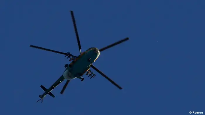 A Syrian Air Force helicopter prepares to fire a rocket during an air strike in Sakhur district, in the center of Aleppo city, August 23, 2012. REUTERS/Youssef Boudlal (SYRIA - Tags: CIVIL UNREST)