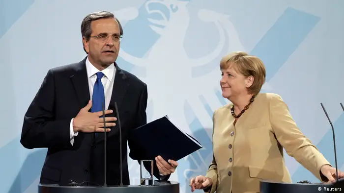 German Chancellor Merkel and Greek Prime Minister Samaras leave after news conference in Berlin